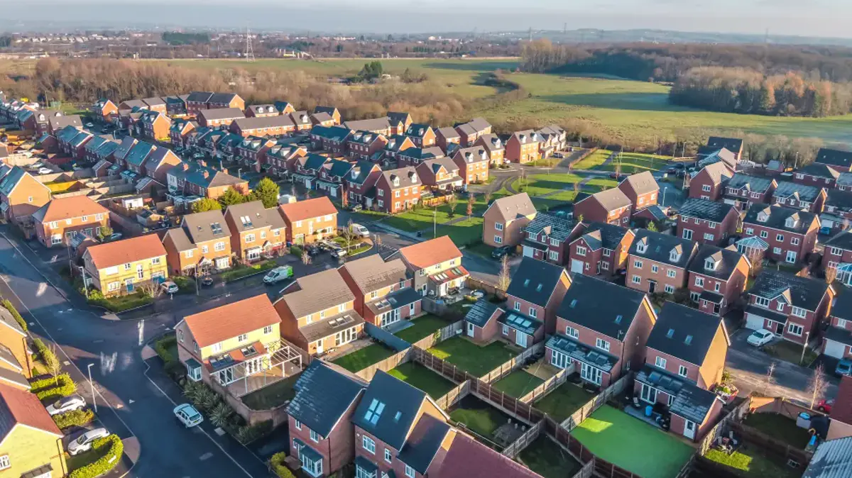 An aerial view of a housing estate of red-brick homes