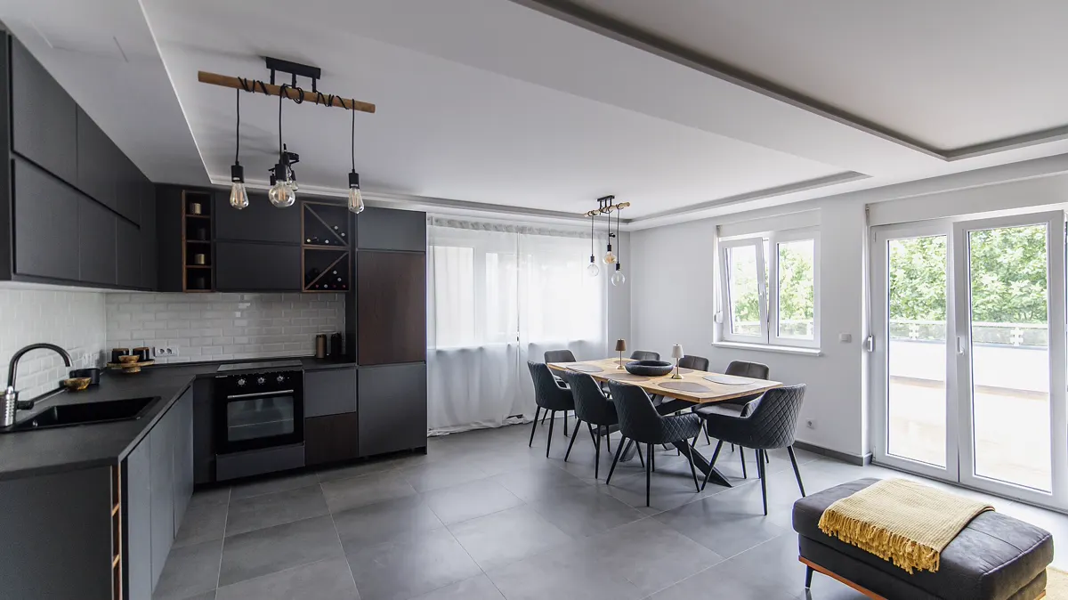 A bright modern kitchen and dining area with a table and chairs