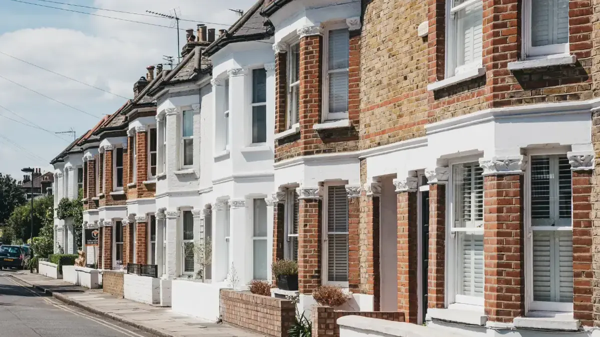 A street of brick and white-fronted terraced houses in London